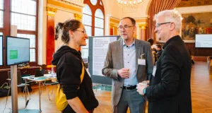 Gespräch zwischen drei Personen am Thementisch 