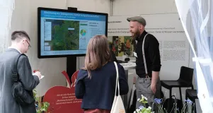 Besucher*innen der Woche der Umwelt informieren sich am Infostand über das Projekt MonVia