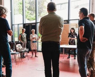 Participants stand in a circle.